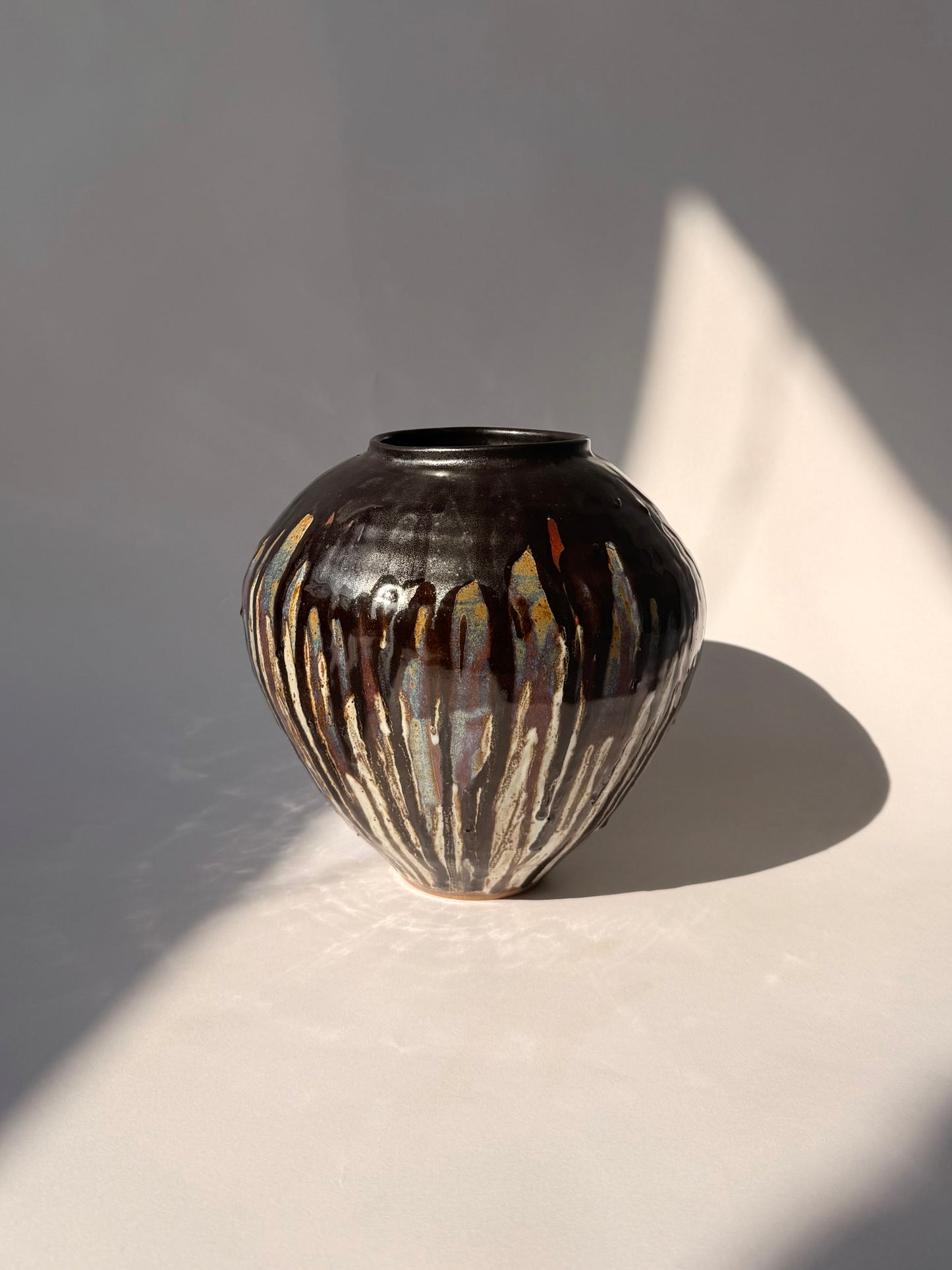 hand-thrown black drip glaze stoneware vessel