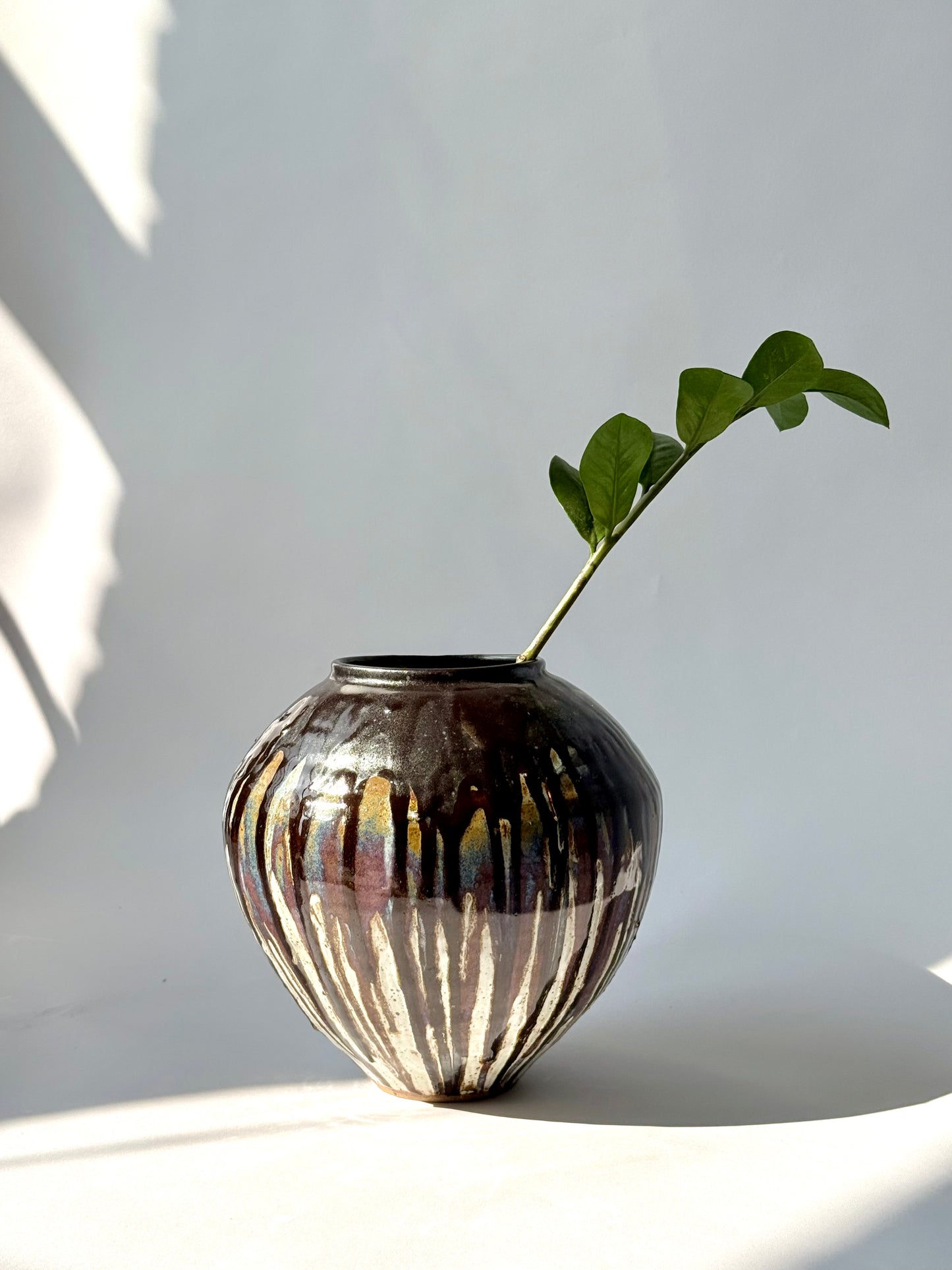 hand-thrown black drip glaze stoneware vessel